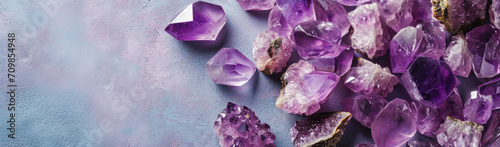 Amethyst crystal banner with concrete background with copy space, many beautiful purple gemstone close-up luxury backdrop. Concepts of spirituality and healing, precious gems and minerals collection photo