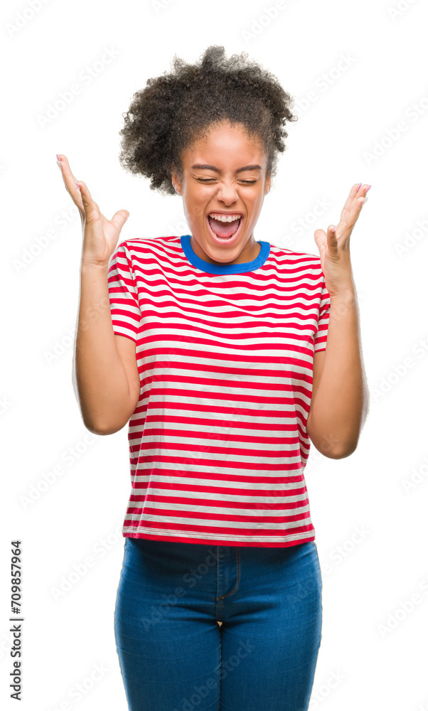 Young afro american woman over isolated background celebrating mad and crazy for success with arms raised and closed eyes screaming excited. Winner concept Young afro american woman over isolated background celebrating mad and crazy for success with arms raised and closed eyes screaming excited. Winner concept