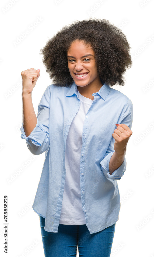 Young afro american woman over isolated background very happy and excited doing winner gesture with arms raised, smiling and screaming for success. Celebration concept. Young afro american woman over isolated background very happy and excited doing winner gesture with arms raised, smiling and screaming for success. Celebration concept.