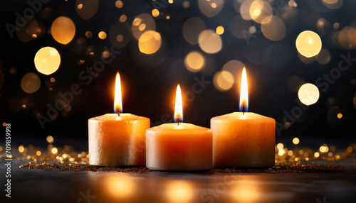 closeup of 3 burning candles on abstract black background, contemplate celebration mood with blurry lights, festive concept with copy space