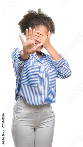 Young afro american woman over isolated background covering eyes with hands and doing stop gesture with sad and fear expression. Embarrassed and negative concept.