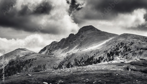 Minimalist mountain landscape with dramatic sky; black and white image