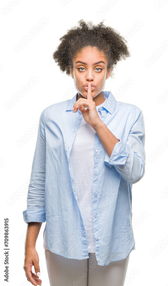 Young afro american woman over isolated background asking to be quiet with finger on lips. Silence and secret concept. Young afro american woman over isolated background asking to be quiet with finger on lips. Silence and secret concept.