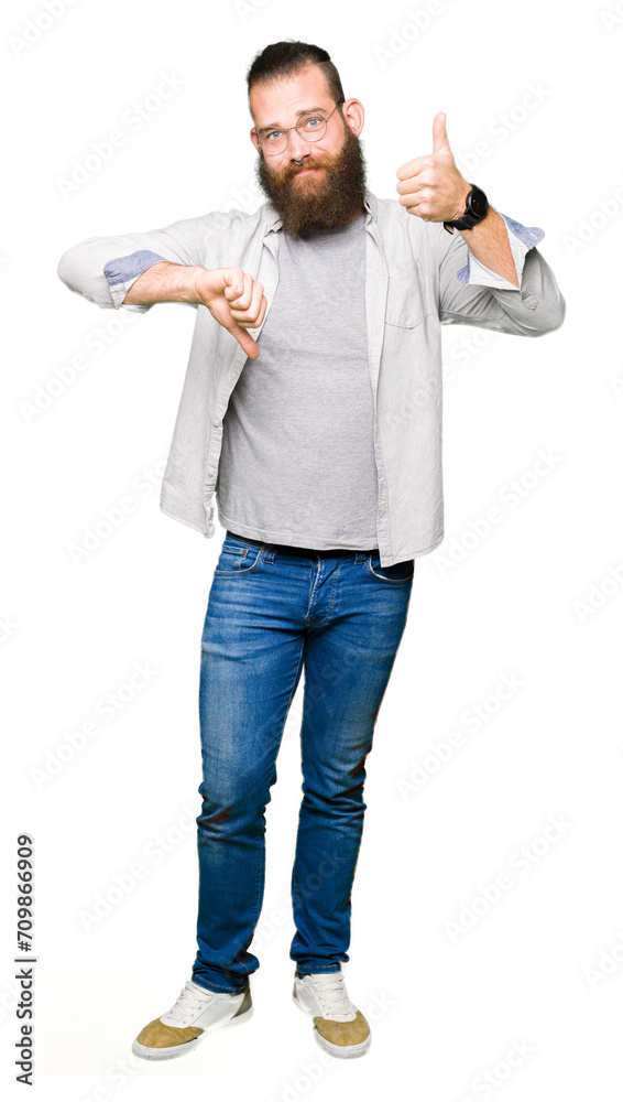 Young blond man wearing glasses Doing thumbs up and down, disagreement and agreement expression. Crazy conflict Young blond man wearing glasses Doing thumbs up and down, disagreement and agreement expression. Crazy conflict
