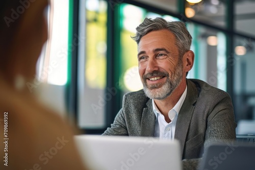 Smiling middle aged mature older business man hr manager, lawyer, bank adviser having work conversation at office meeting or job interview. Financial legal advisory and consultancy, Generative AI photo
