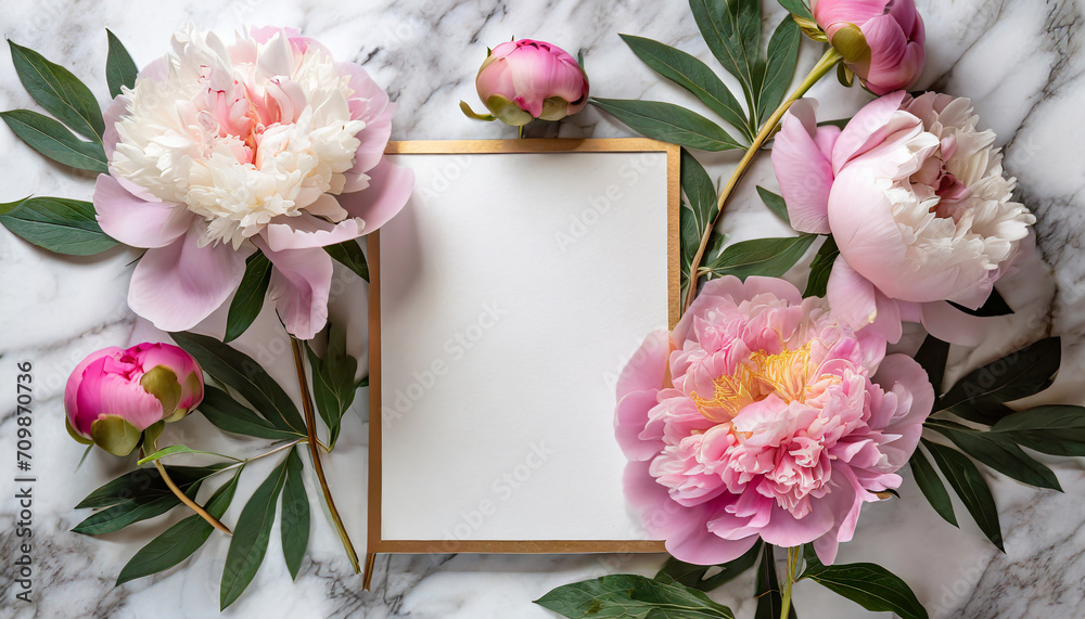Blank greeting card in frame made of pink peony flowers on white marble background. Wedding invitation. Mock up. Flat lay - obrazy, fototapety, plakaty 