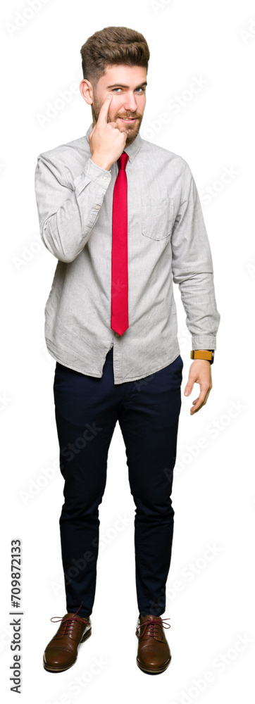 Young handsome business man Pointing to the eye watching you gesture, suspicious expression Young handsome business man Pointing to the eye watching you gesture, suspicious expression