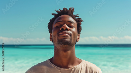 man outdoors with a serene expression on her face, enjoying the moment, beach backdrop relaxed summer happy fresh air nature handsome