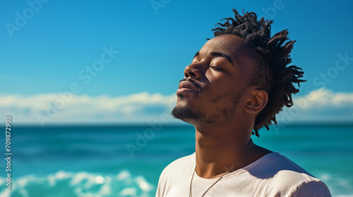 man outdoors with a serene expression on her face, enjoying the moment, beach backdrop relaxed summer happy fresh air nature