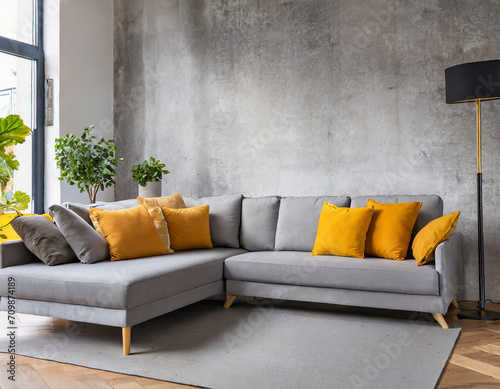 Grey corner sofa with mustard color pillows against concrete wall. Scandinavian home interior design of modern living room.