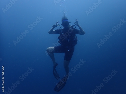 scuba diver in the underwater  portrait  deep blue  chill and OK sign