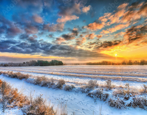 HDR landscape of a beautiful sunrise on a snowy field