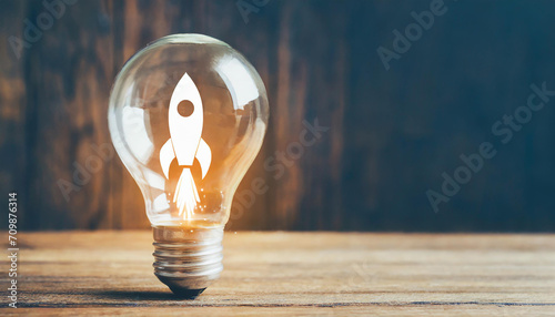 Rocket launch idea inside lightbulb with arrows up. strategically planning and initiating a corporate startup. aim to achieve objectives through value development, fostering leadership