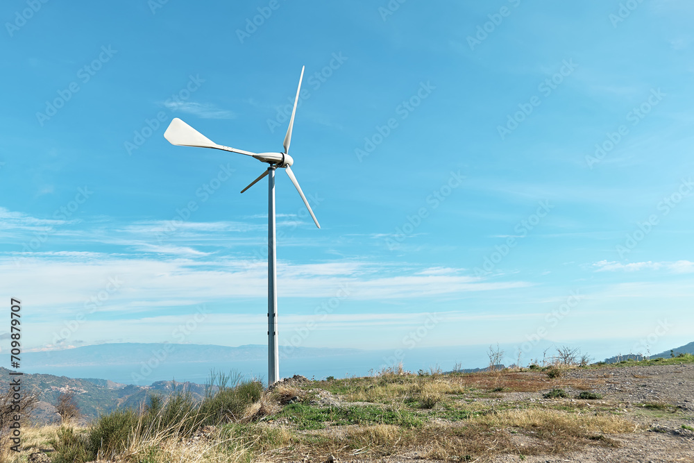 Fototapeta premium Green energy concept. Мountain top industrial wind power plant, wind turbine for generation electricity in wind farm or wind park.