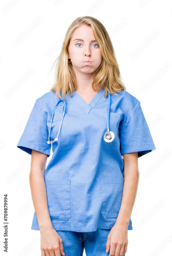 Beautiful young doctor woman wearing medical uniform over isolated background puffing cheeks with funny face. Mouth inflated with air, crazy expression. Beautiful young doctor woman wearing medical uniform over isolated background puffing cheeks with funny face. Mouth inflated with air, crazy expression.