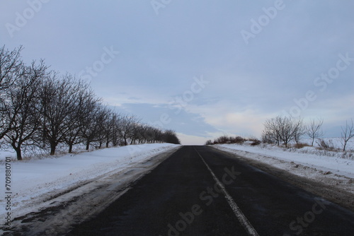 A road with snow on the side
