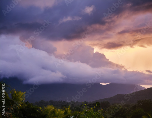 Dense Raining clouds over the mountain at sunset; tropical country