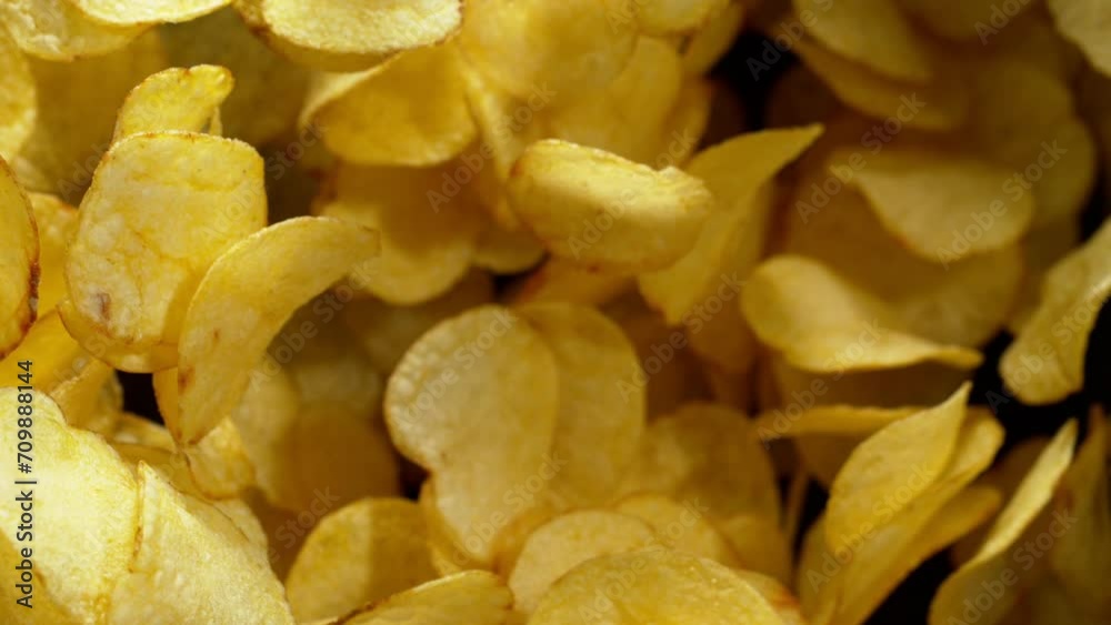 Super slow motion of flying fried potatoes chips on black background. Filmed on high speed cinema camera, 1000 fps. Speed ramp effect. Super slow motion of flying fried potatoes chips on black background. Filmed on high speed cinema camera, 1000 fps. Speed ramp effect.