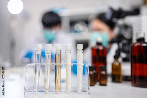 A sample test tube of fat, milk, glucose and protein in laboratory, dairy factory product analyze, quality checking and control test, microbiology technician scientist or nutrition test and experiment