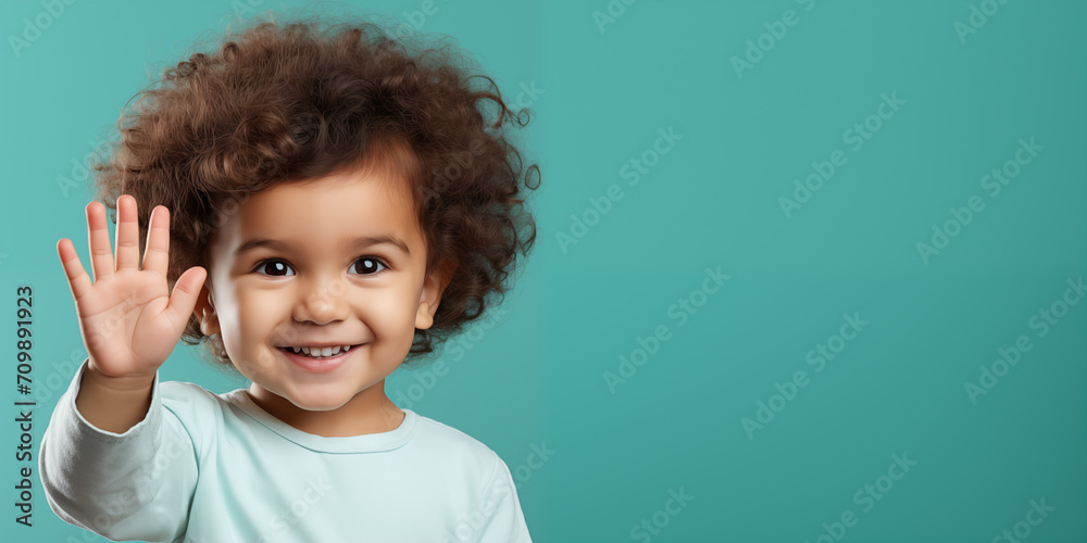 Banner with cute smiling boy pointing five with empty space for text over teal background Banner with cute smiling boy pointing five with empty space for text over teal background