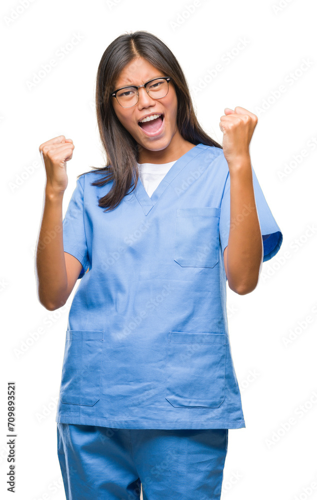 Young asian doctor woman over isolated background very happy and excited doing winner gesture with arms raised, smiling and screaming for success. Celebration concept. Young asian doctor woman over isolated background very happy and excited doing winner gesture with arms raised, smiling and screaming for success. Celebration concept.
