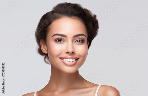 Beautiful young woman portrait, Smiling cute woman studio shot, isolated on gray background. People, beauty, cosmetics concept 