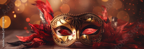 carnival mask with golden feathers on bokeh background © Daniel