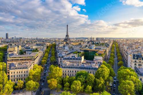 Aerial view of Paris with Eiffel Tower and Champs Elysees from the roof of the Triumphal Arch. Panoramic sunset view of old town of Paris. Popular travel destination © samael334