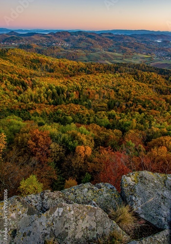 Scenic autumn morning sunrise on Sitno hill over Banska Stiavnica in Slovakia, colorful leaves of trees in forest on the mountains and beautiful light on sky. © Ivan