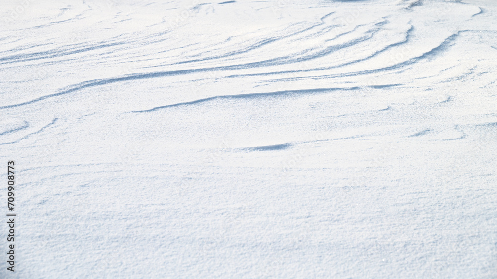 Fresh snow texture in blue tone as background.