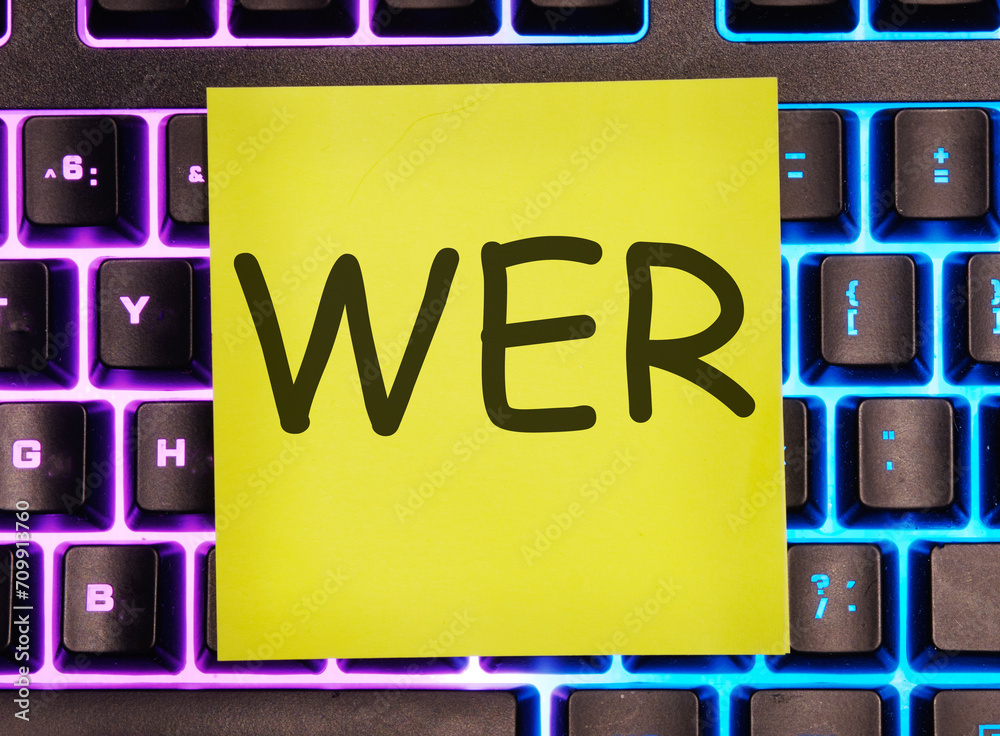 Who, German word for Who, (German: Wer) written on a yellow sticker on a laptop keyboard with backlight