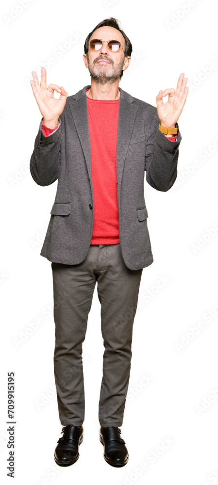 Middle age handsome business man wearing sunglasses relax and smiling with eyes closed doing meditation gesture with fingers. Yoga concept. Middle age handsome business man wearing sunglasses relax and smiling with eyes closed doing meditation gesture with fingers. Yoga concept.