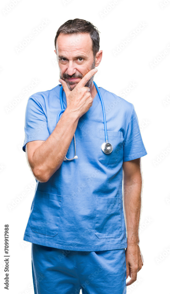 Middle age hoary senior doctor man wearing medical uniform over isolated background looking confident at the camera with smile with crossed arms and hand raised on chin. Thinking positive. Middle age hoary senior doctor man wearing medical uniform over isolated background looking confident at the camera with smile with crossed arms and hand raised on chin. Thinking positive.