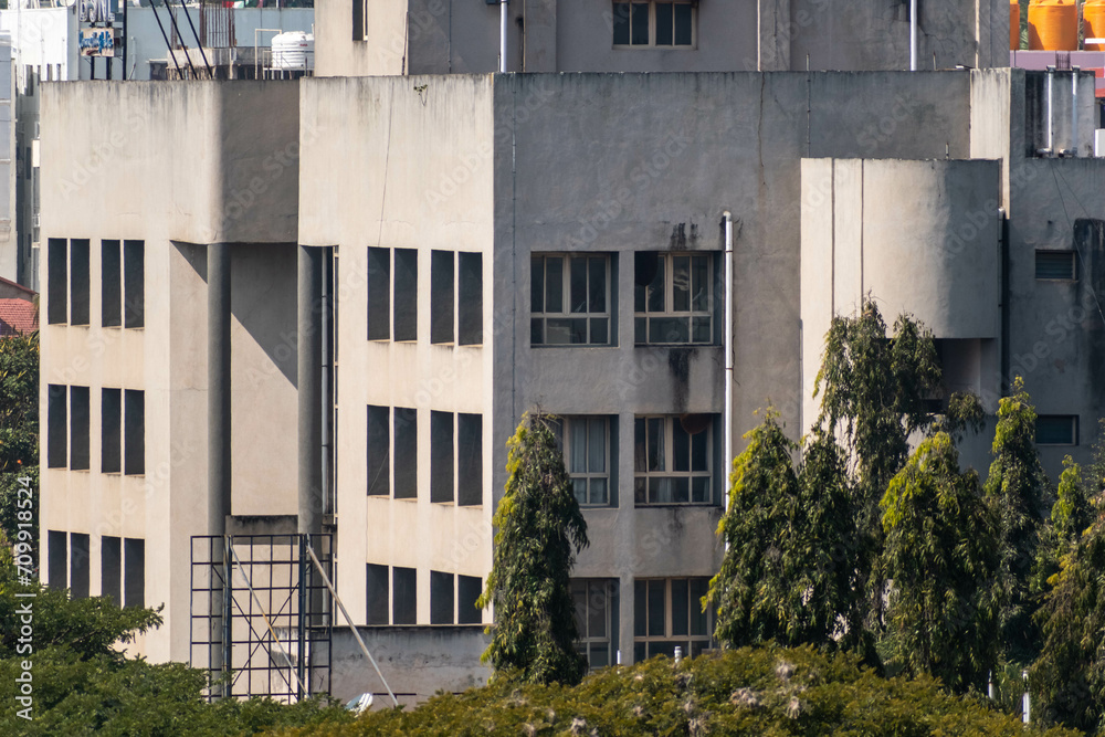 A modern concrete building with square windows in the town of Hassan