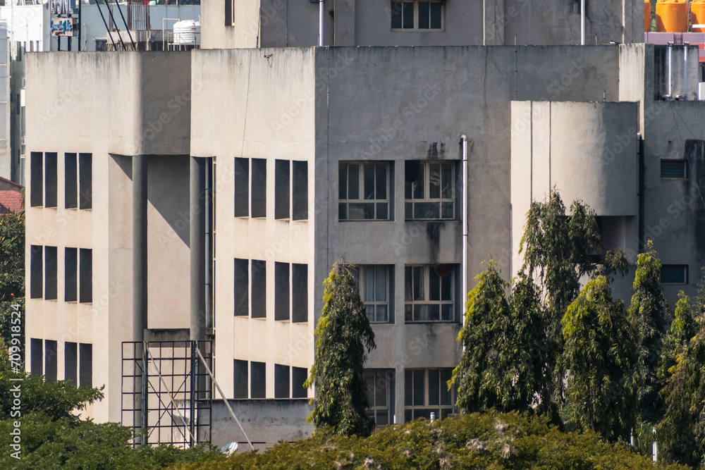 A modern concrete building with square windows in the town of Hassan A modern concrete building with square windows in the town of Hassan