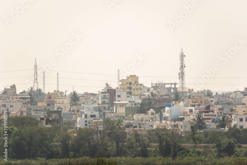 A cityscape of rooftops of low rise houses in the town of Hassan.