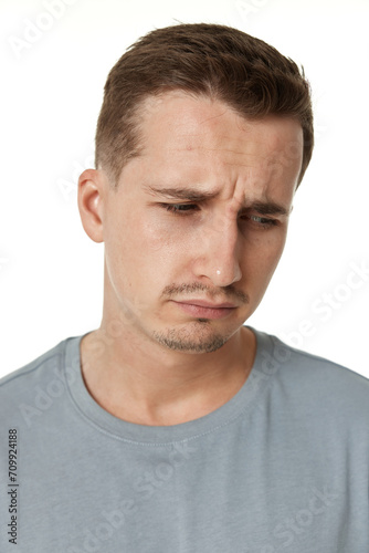 offended frustrated young man on white background. sadness © producer