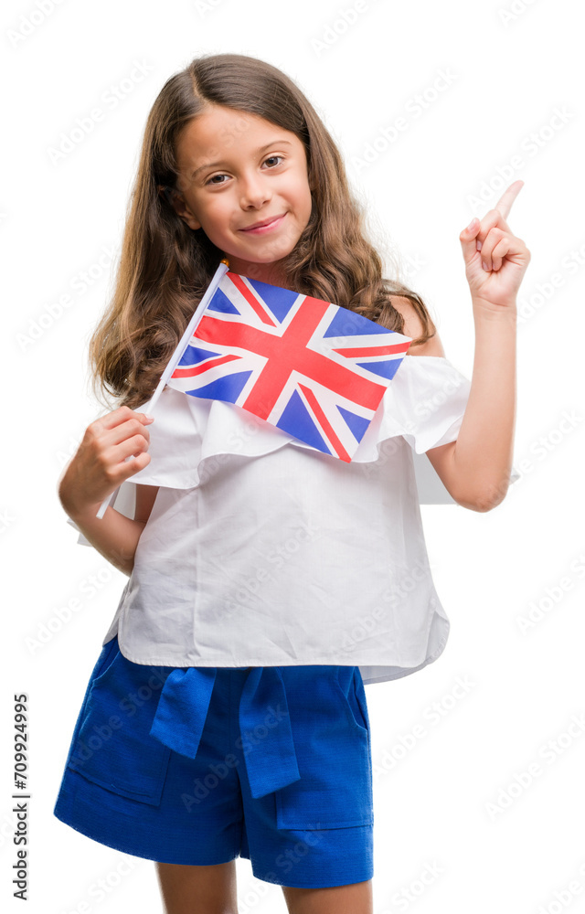Brunette hispanic girl holding flag of United Kingdom very happy pointing with hand and finger to the side Brunette hispanic girl holding flag of United Kingdom very happy pointing with hand and finger to the side