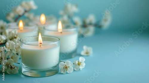 trendy aroma candles on a pastel background with flowers around 
