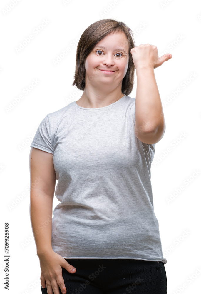 Young adult woman with down syndrome over isolated background smiling with happy face looking and pointing to the side with thumb up. Young adult woman with down syndrome over isolated background smiling with happy face looking and pointing to the side with thumb up.