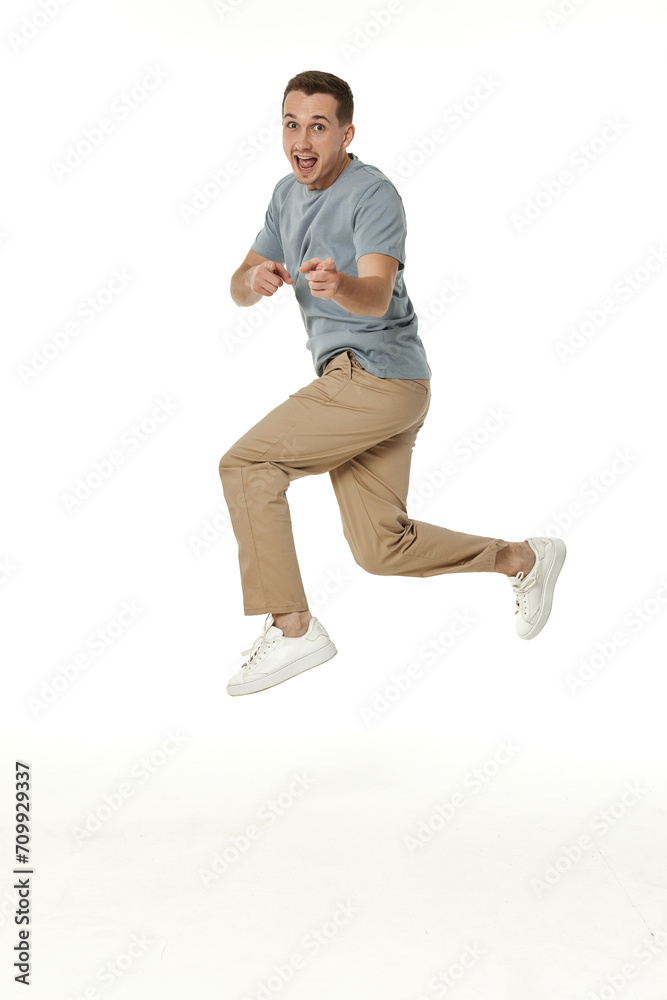 Fototapeta premium happy guy looking pointing at the camera on white studio background