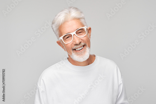 Portrait gray-haired man smiling joyfully with happy face isolated on white studio background, advertising banner.