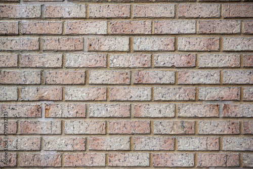 Modern beige brick wall background texture. Home and office interior design backdrop. 