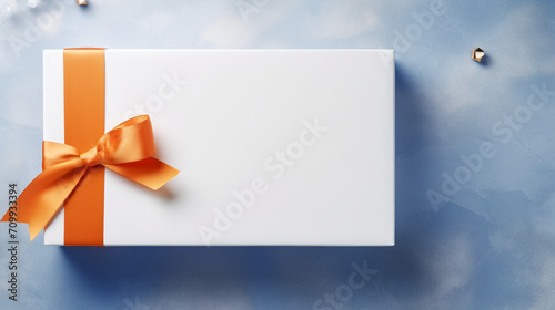There is an open rectangular empty white box on an orange table, a blue ribbon lies next to it created with Generative Ai