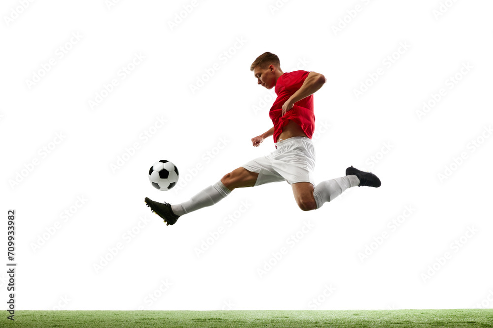 Aerial Symphony of Soccer. Athleticism. Portrait of soccer maestro orchestrates airborne pass, the ball dancing through air against white background with green field. Concept of sport games, match.