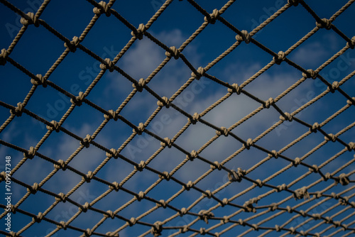 Rope link fence with sky