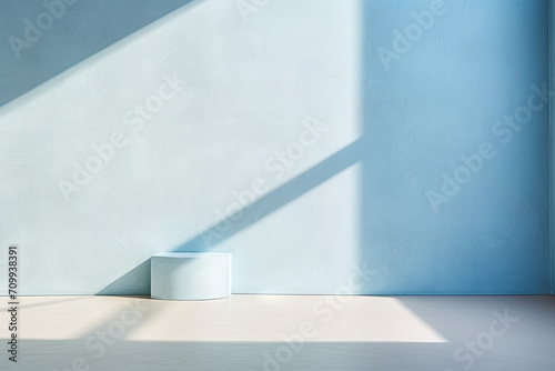 Minimal abstract light blue background for product presentation. Shadow and light from windows on plaster wall. photo