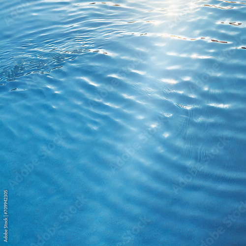 sunlight in water surface from above, empty blue banner with copy space, beautiful abstract water texture background concept for cosmetics, pharmacy, body care, water resource, drink