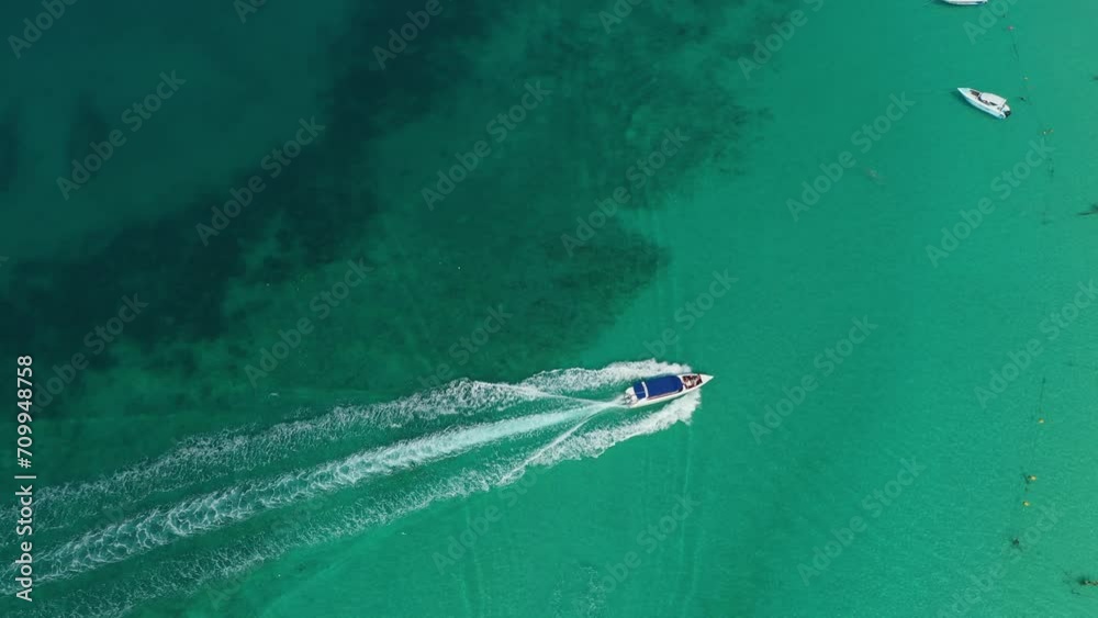 Parking of pleasure tourist boats during an island hopping tour on the tropical beaches of Asia. Arrival of speedboat in blue lagoon View from above top aerial.