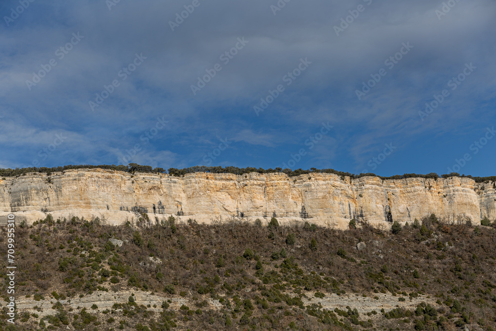 Vertical rock walls, forests and blue sky. Puentedey, Las Merindades Region, Burgos, Spain.